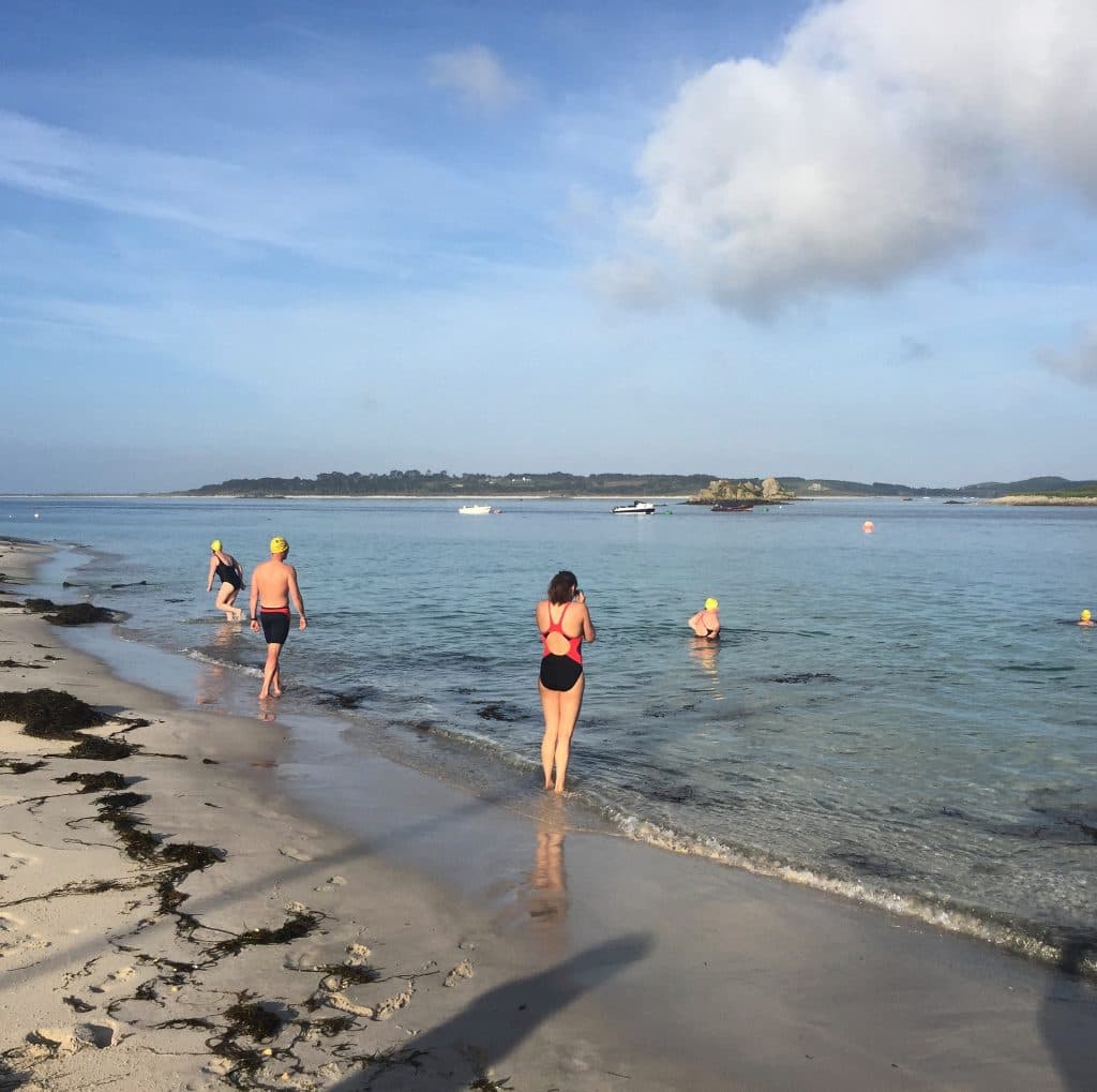 Swimmers entering the sea at the the Scilly Isles