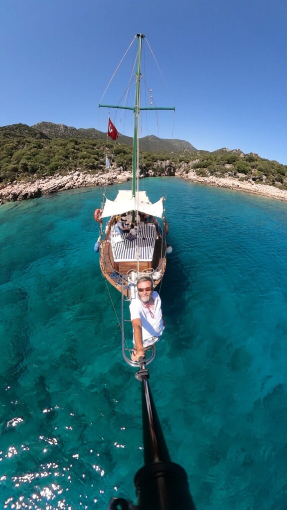 Boat in beautiful blue sea with passengers and captain