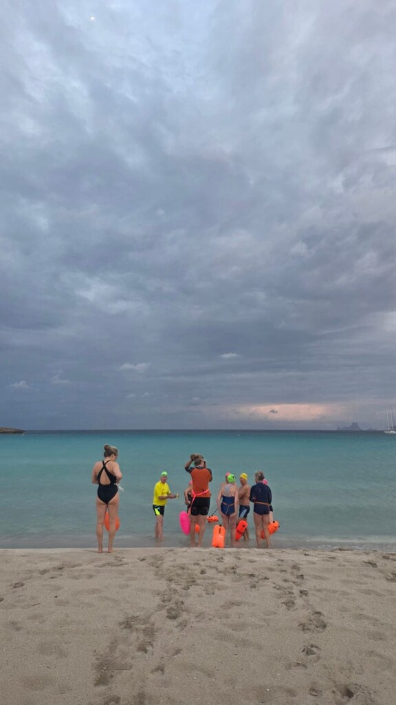 Swimmers entering water formentera beach