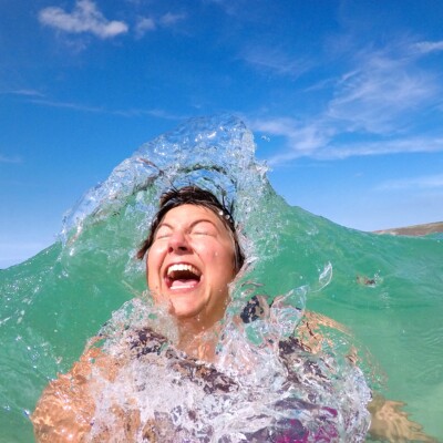 Swimmer in the water jumping in the waves