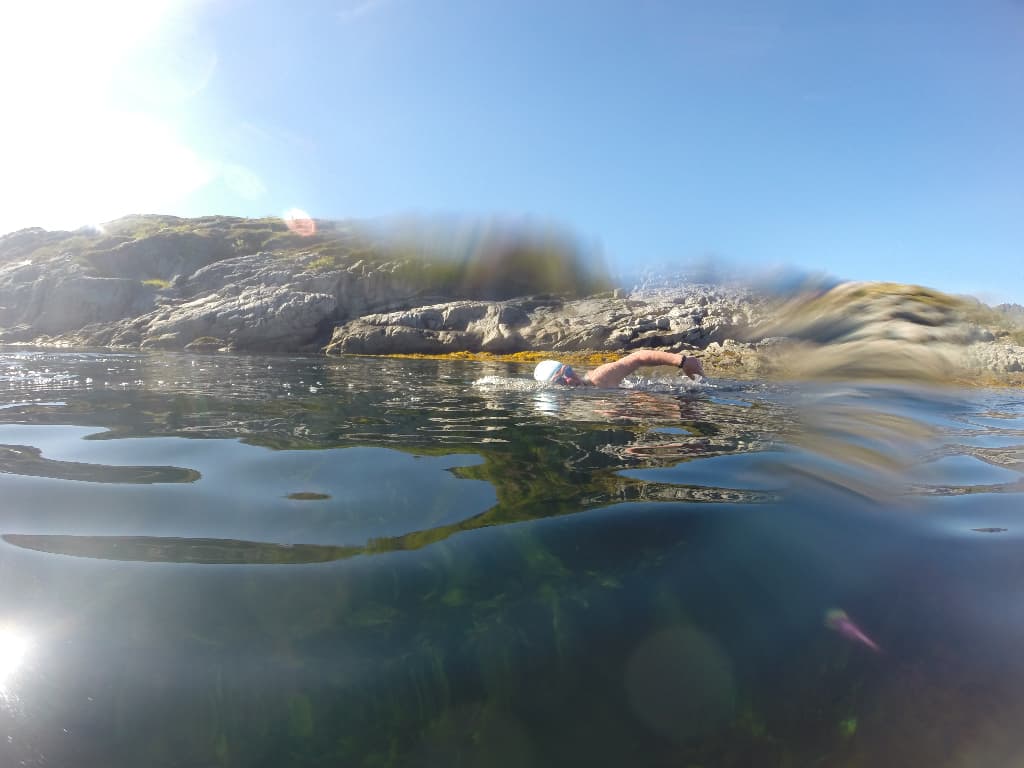 Swimmer in water at Lofoten