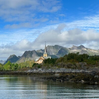 Church nestled in trees and mountains in Lofoten