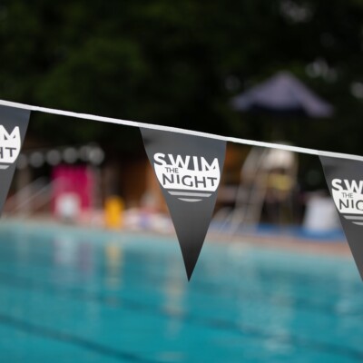 Swim the Night flags over pool