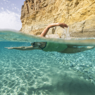 Swimmer in turquoise water in Greece front crawl