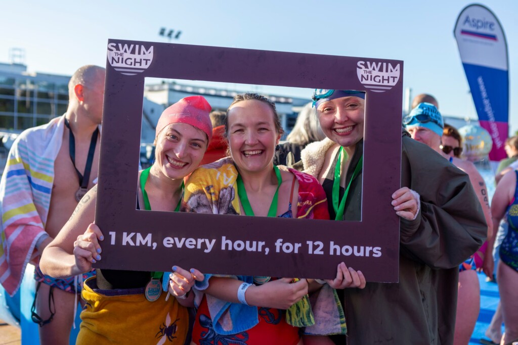 Swim the Night participants smiling at the finish