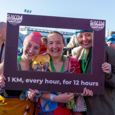 Swim the Night participants smiling at the finish