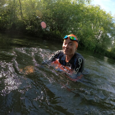 Swimmer with tow float in river